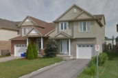 brown detached two story house with white doors, windows, and a white garage