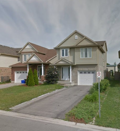 brown detached two story house with white doors, windows, and a white garage