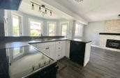 kitchen showing fireplace, double sink and large windows