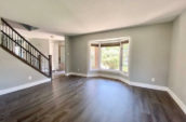 room with wooden floor leading to staircase