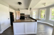 modern kitchen with large windows and wooden floor